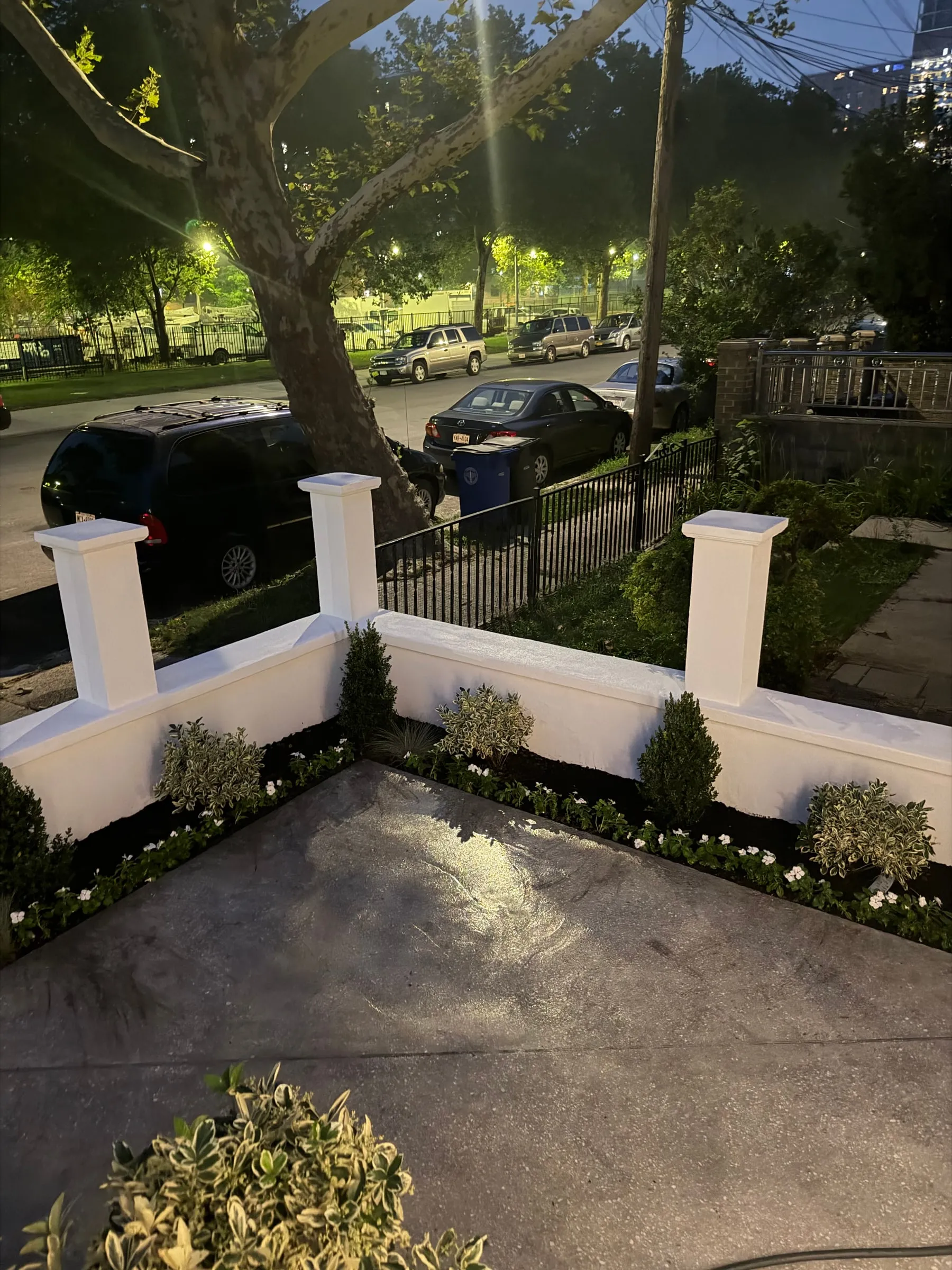 The finished frontage after dark, planting in and lit.