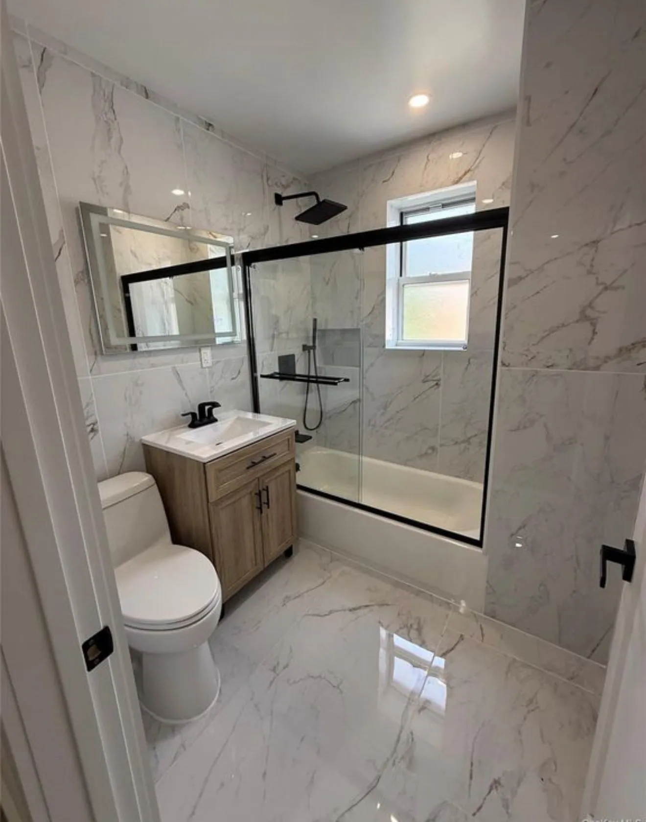 Main bathroom, tiled floor to ceiling.