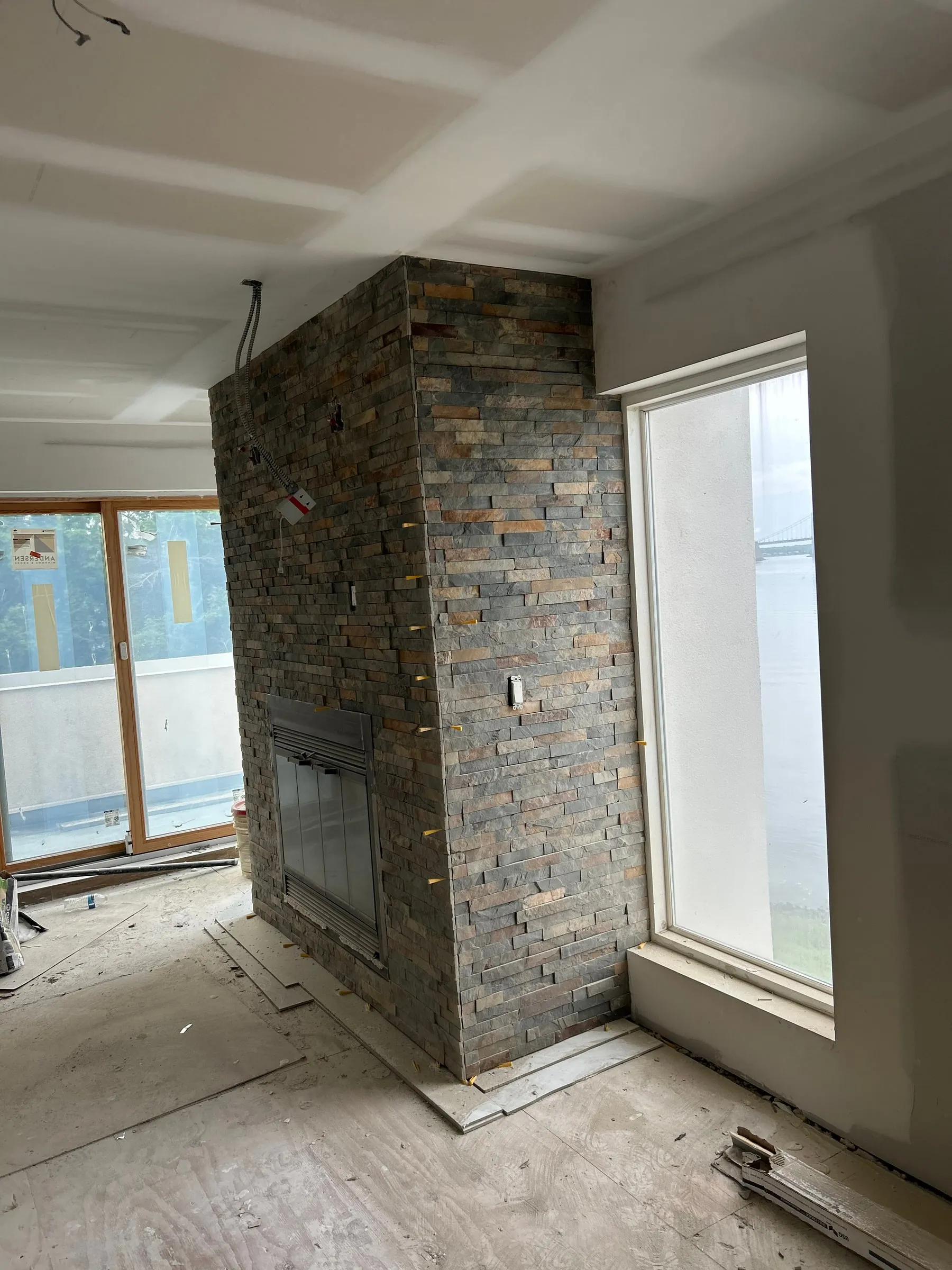 The chimney breast built in stacked stone and carried the full height of the room.